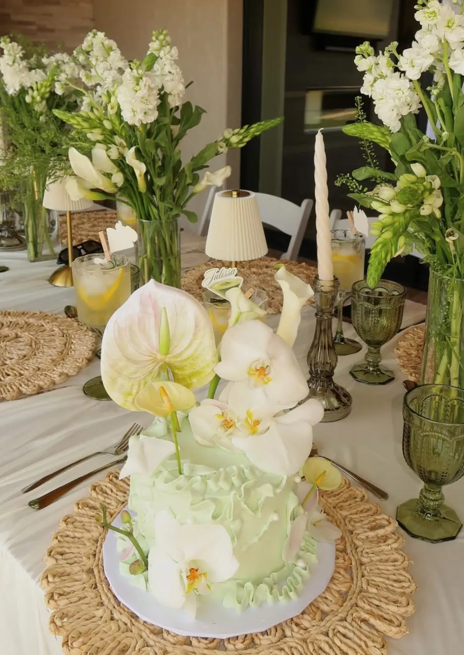 Green ruffle cake topped with white orchids and anthuriums